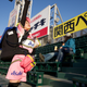 A vendor hawks Asahi beer and snacks in the stands.